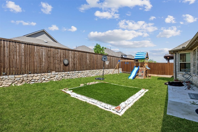 view of yard featuring a playground and a fenced backyard