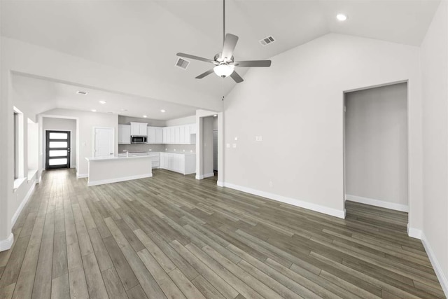 214 Fairmont, Princeton, TX 75407 - unfurnished living room featuring visible vents, wood finished floors, ceiling fan, and lofted ceiling