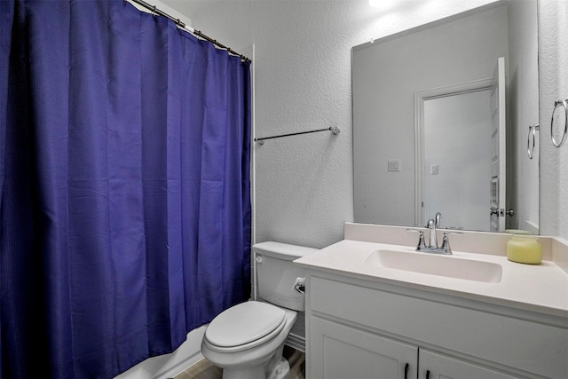 7005 Lowbranch Trl, Little Elm, TX 76227 - bathroom with toilet, a textured wall, and vanity