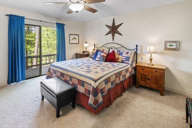 bedroom with access to exterior, a textured ceiling, and light colored carpet