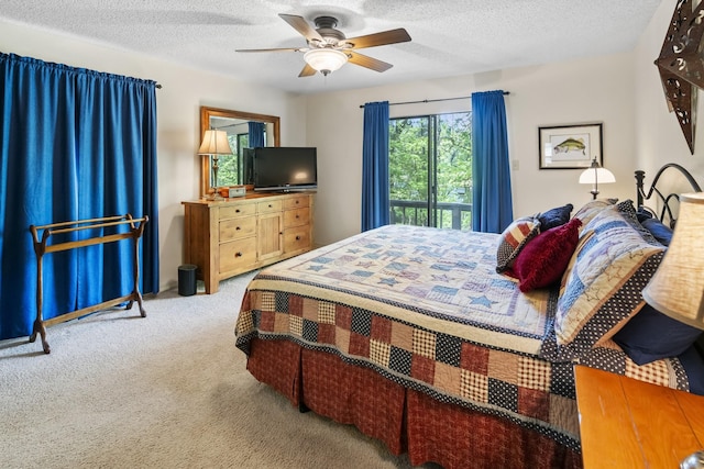 carpeted bedroom featuring a textured ceiling and ceiling fan