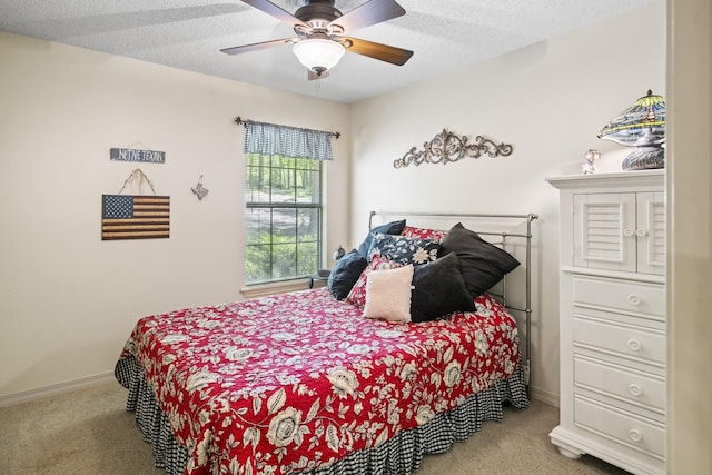 bedroom with a textured ceiling, a ceiling fan, baseboards, and carpet floors