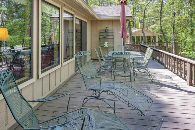 wooden terrace with outdoor dining area