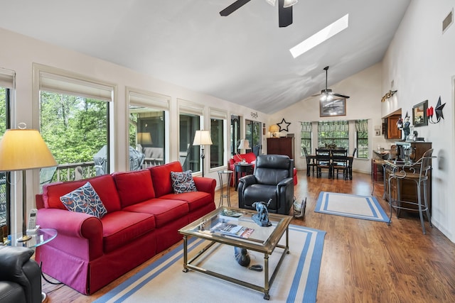 living area with a ceiling fan, visible vents, a skylight, and plenty of natural light
