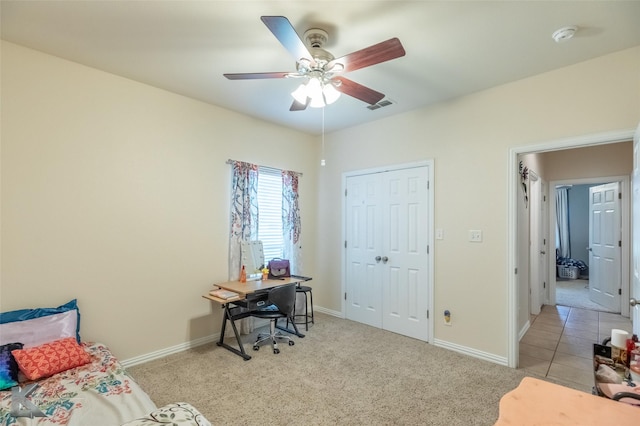bedroom with light carpet, a ceiling fan, baseboards, visible vents, and a closet