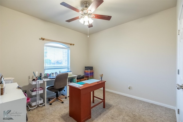 home office featuring baseboards, ceiling fan, and light colored carpet