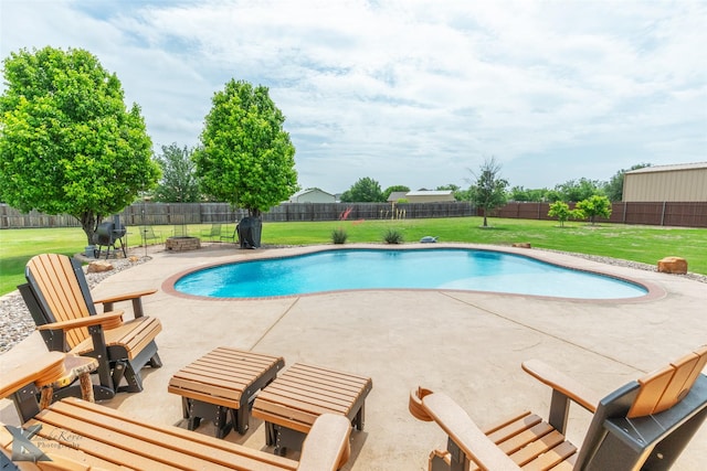 view of pool featuring a lawn, a patio, a fire pit, and a fenced backyard