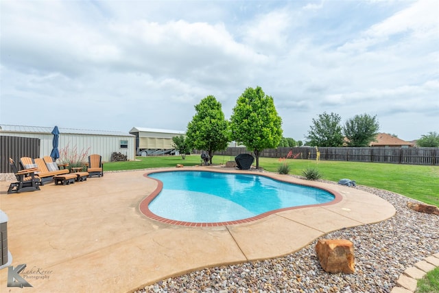 view of swimming pool with a lawn, a fenced backyard, a patio area, and a fenced in pool