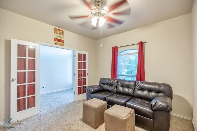 living room featuring a ceiling fan, baseboards, french doors, and carpet