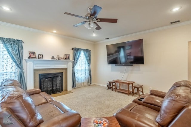 carpeted living room with a fireplace with flush hearth, ceiling fan, ornamental molding, and visible vents