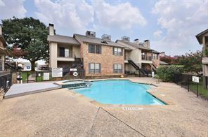community pool with fence, a community hot tub, and a patio area