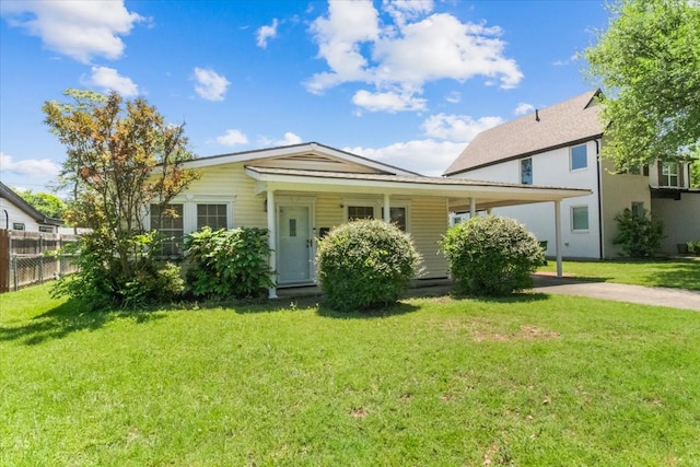 5841 Tracyne Dr, Westworth Village, TX 76114 - view of front facade with fence, a carport, driveway, and a front yard