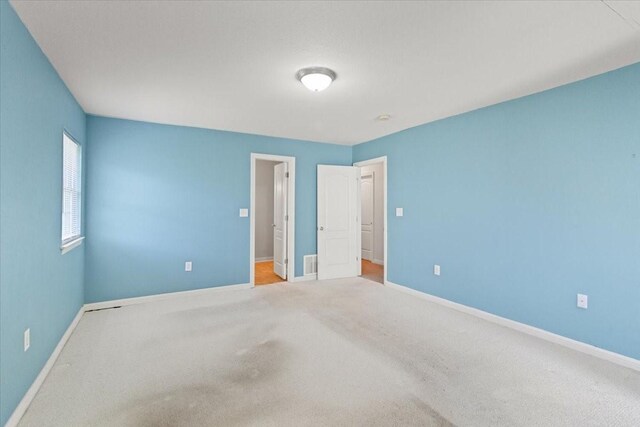 5841 Tracyne Dr, Westworth Village, TX 76114 - unfurnished bedroom with visible vents, carpet floors, and baseboards