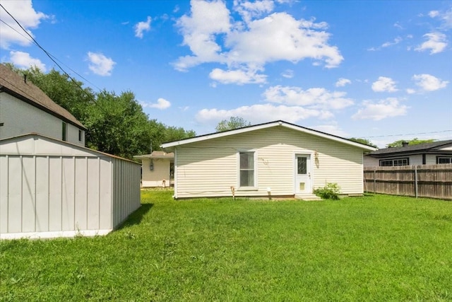 5841 Tracyne Dr, Westworth Village, TX 76114 - rear view of house featuring an outbuilding, a lawn, entry steps, and fence