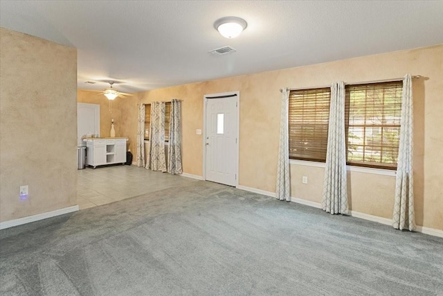 5841 Tracyne Dr, Westworth Village, TX 76114 - unfurnished living room with a ceiling fan, visible vents, carpet, and baseboards