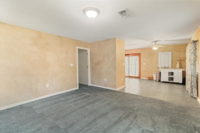 5841 Tracyne Dr, Westworth Village, TX 76114 - unfurnished living room with carpet floors, tile patterned floors, baseboards, visible vents, and a ceiling fan