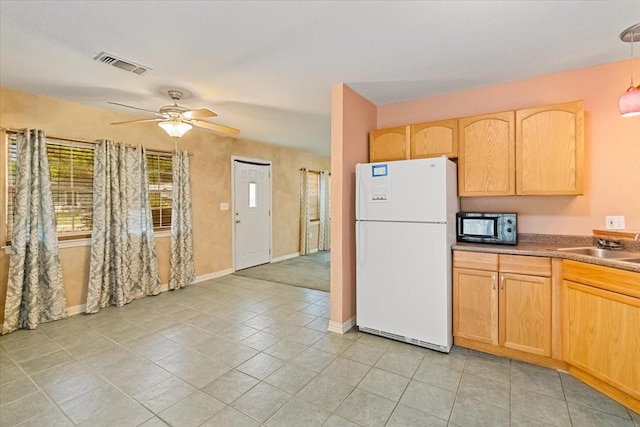 5841 Tracyne Dr, Westworth Village, TX 76114 - kitchen with light brown cabinets, freestanding refrigerator, black microwave, visible vents, and a ceiling fan