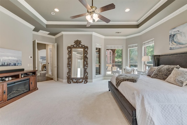 bedroom featuring recessed lighting, baseboards, light carpet, and a tray ceiling
