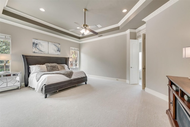 carpeted bedroom with crown molding, visible vents, baseboards, and a tray ceiling