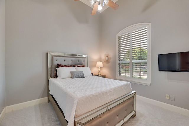 carpeted bedroom with a ceiling fan and baseboards