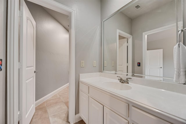 bathroom featuring tile patterned flooring, visible vents, vanity, and baseboards