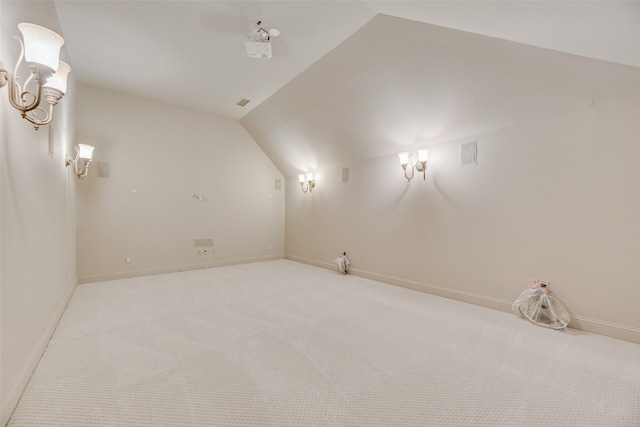 additional living space featuring baseboards, vaulted ceiling, and carpet floors