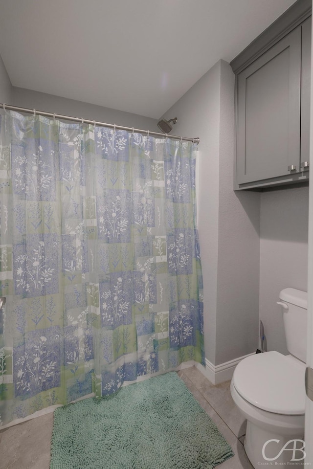 full bath with a shower with curtain, toilet, and tile patterned flooring