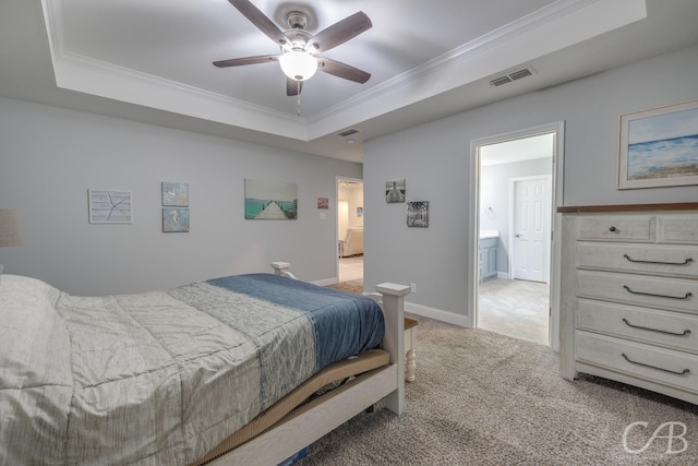 bedroom featuring connected bathroom, a raised ceiling, visible vents, light carpet, and ornamental molding