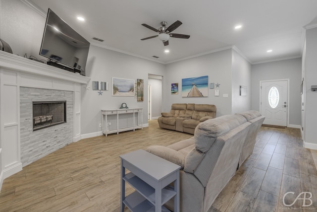 living room with recessed lighting, wood finished floors, a ceiling fan, and a stone fireplace