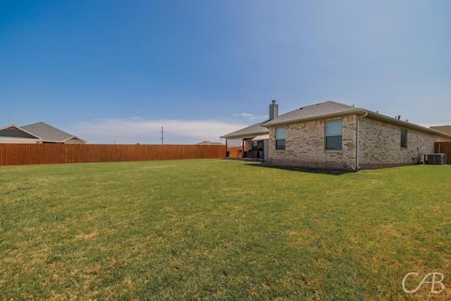 view of yard featuring cooling unit and fence