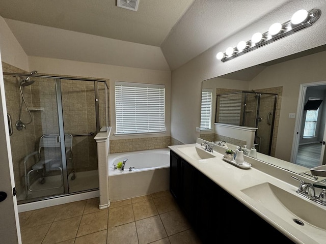101 Holly St, Waxahachie, TX 75165 - bathroom with a garden tub, a shower stall, tile patterned floors, double vanity, and lofted ceiling