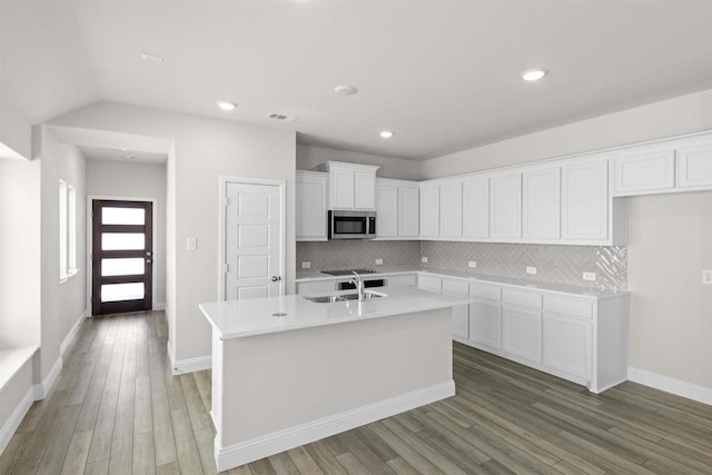 1640 Meadow Crst, Aubrey, TX 76227 - kitchen featuring stainless steel microwave, a sink, light wood-type flooring, tasteful backsplash, and recessed lighting