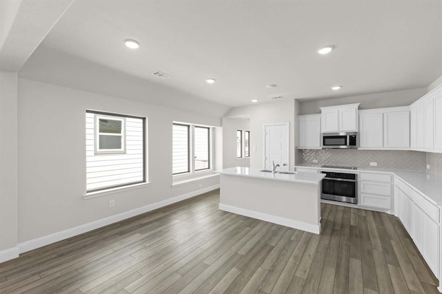 1640 Meadow Crst, Aubrey, TX 76227 - kitchen featuring stainless steel appliances, backsplash, light countertops, white cabinets, and an island with sink
