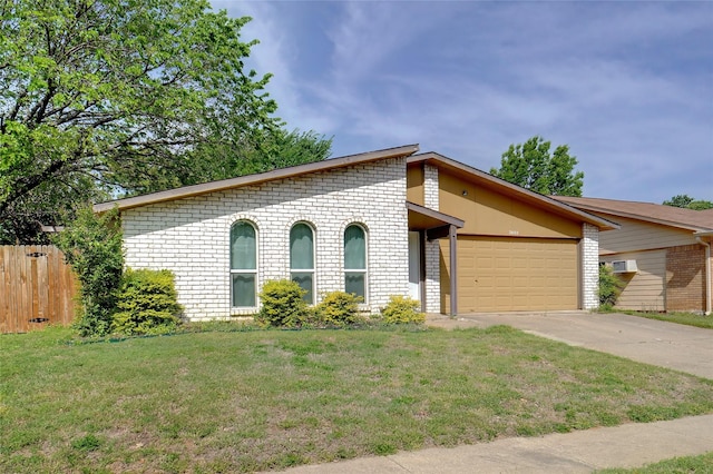 mid-century home with concrete driveway, a front yard, fence, brick siding, and a garage