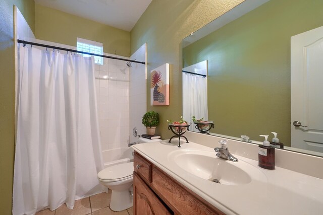 full bathroom with toilet, tile patterned flooring, shower / bathtub combination with curtain, and vanity