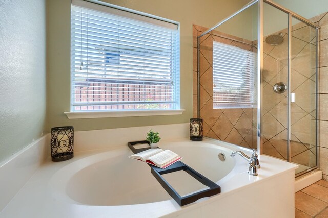 full bathroom featuring a stall shower, tile patterned flooring, and a bath