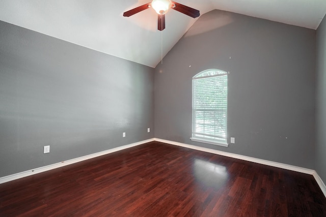 spare room featuring a ceiling fan, lofted ceiling, wood finished floors, and baseboards