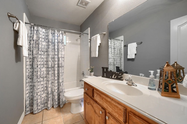 bathroom featuring tile patterned floors, shower / bath combo, toilet, vanity, and visible vents