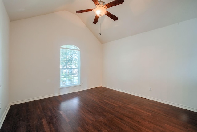 spare room featuring baseboards, a ceiling fan, lofted ceiling, and dark wood-type flooring