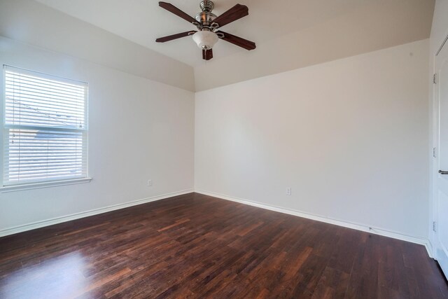 empty room featuring baseboards, wood finished floors, and a ceiling fan