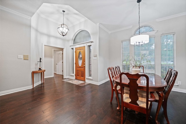 dining space with hardwood / wood-style flooring, crown molding, and a notable chandelier
