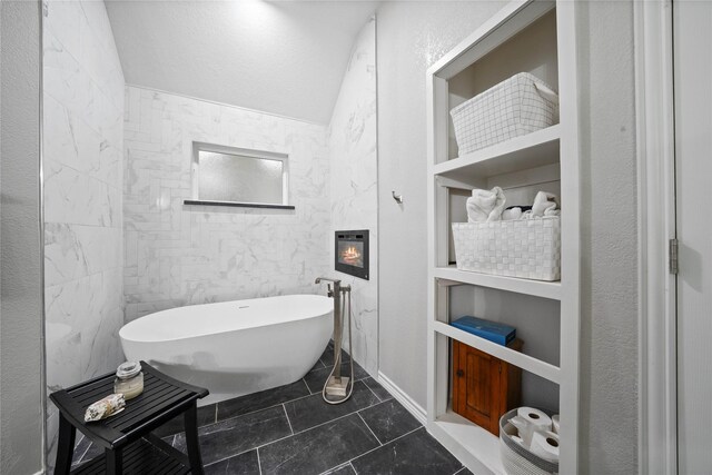 full bath with tile patterned floors and a soaking tub