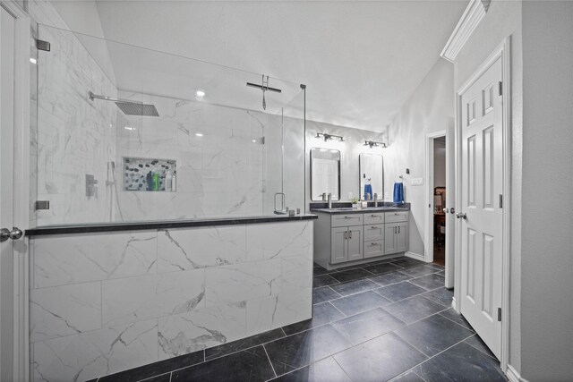 bathroom with a marble finish shower and vanity