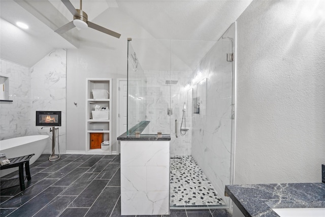 bathroom featuring a ceiling fan, built in shelves, a marble finish shower, and lofted ceiling