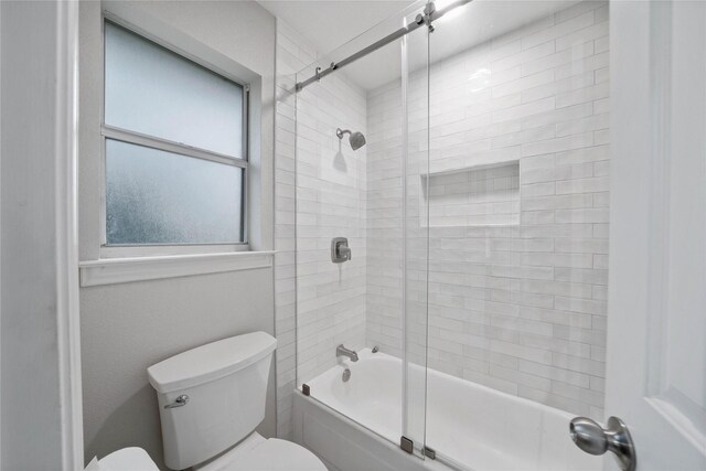 full bath featuring enclosed tub / shower combo and toilet