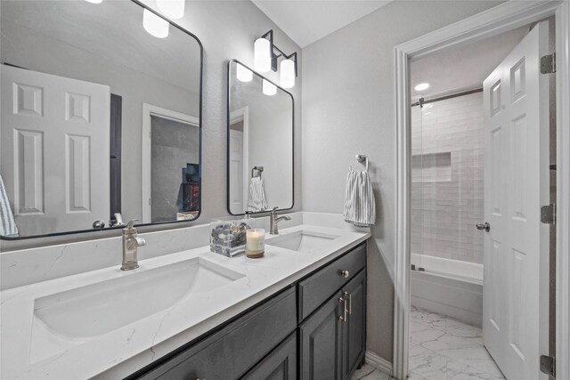 bathroom featuring marble finish floor, a sink, double vanity, and bathing tub / shower combination