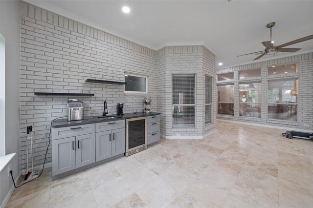 kitchen with a sink, wine cooler, ceiling fan, open shelves, and ornamental molding