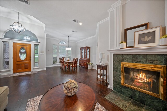 entrance foyer with a chandelier, visible vents, hardwood / wood-style flooring, and ornamental molding