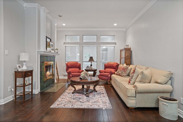 living room featuring a tiled fireplace, recessed lighting, ornamental molding, dark wood-style flooring, and baseboards