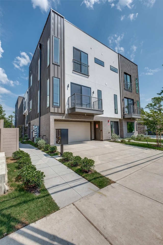 4517 Munger Ave Unit 106, Dallas, TX 75204 - view of building exterior featuring concrete driveway and an attached garage